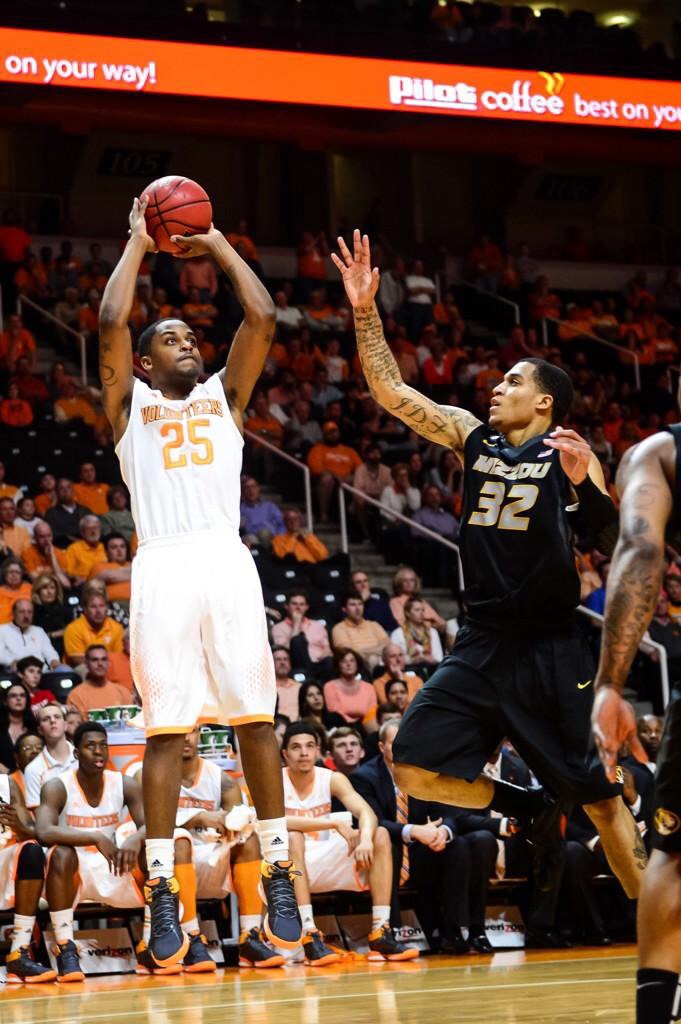 Galen Campbell in his white Tennessee Volunteers uniform, number 25, shooting over a defender during a home game at Tennessee